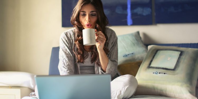 Woman in grey working from home