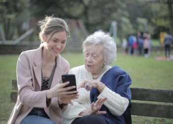 cheerful-senior-mother-and-adult-daughter-using-smartphone
