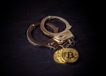 Bit coin and handcuffs