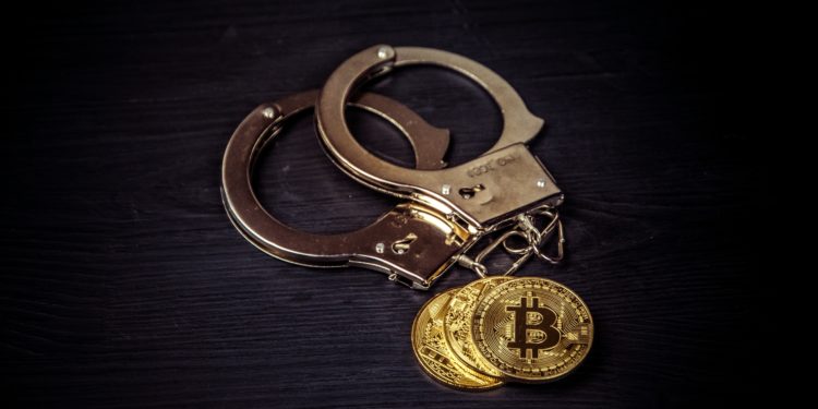 Bit coin and handcuffs