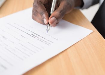 Man filling out a law document