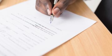 Man filling out a law document