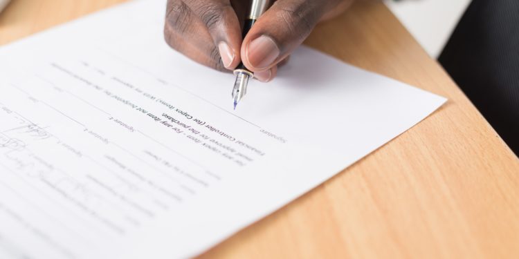 Man filling out a law document