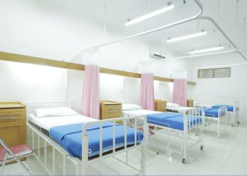 Hospital ward full of empty beds