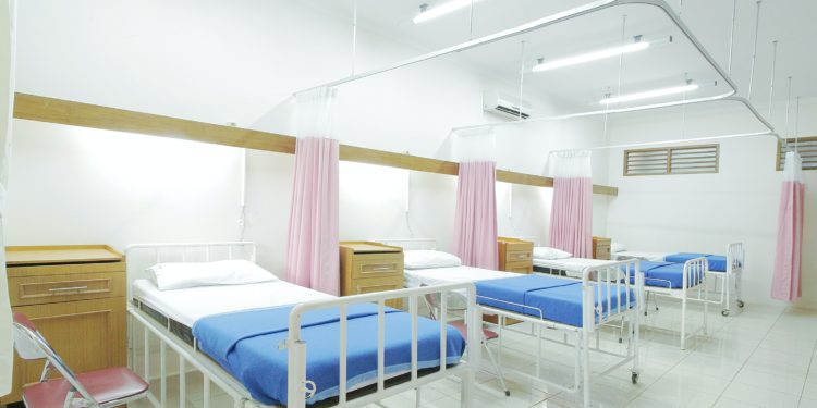 Hospital ward full of empty beds
