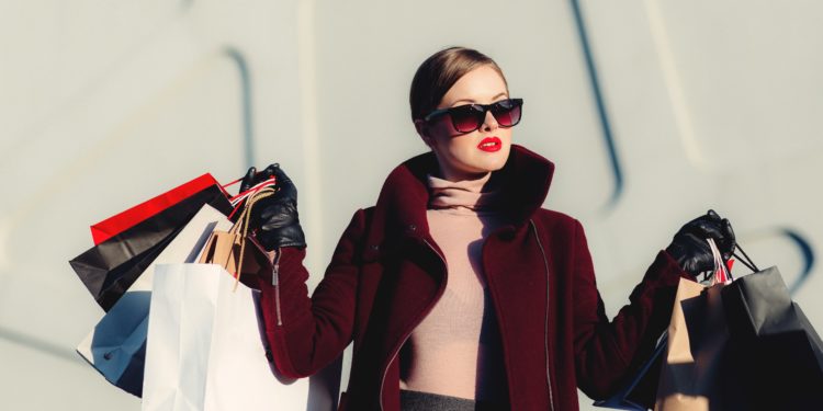 Chic woman shopping with multiple bags