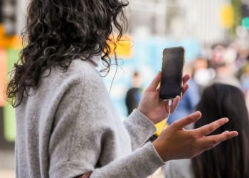 Woman on a video call using an android in a busy street