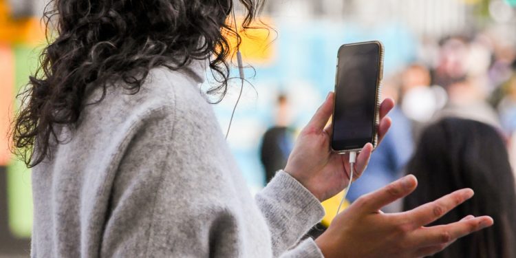 Woman on a video call using an android in a busy street