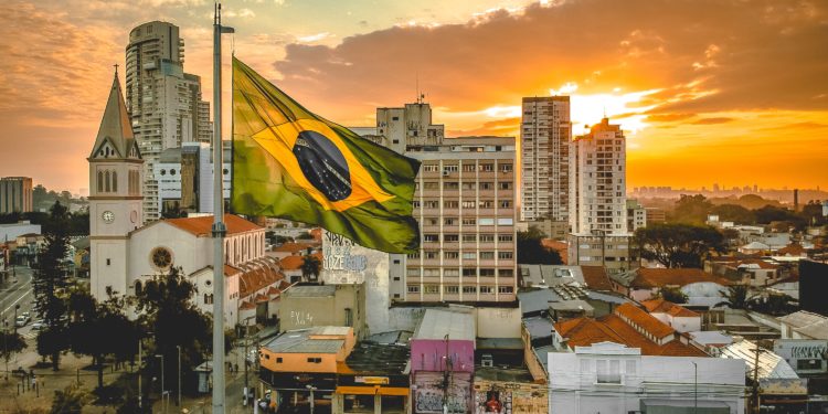 Brazillian skyline with flag in the forefront