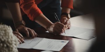 People signing documents