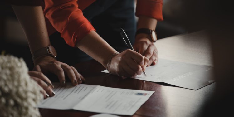 People signing documents