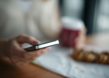 Person on phone at breakfast