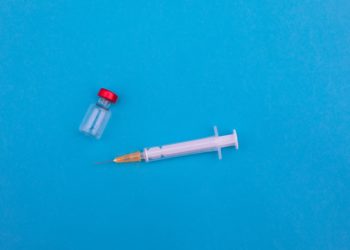 Empty vaccine vial and needle