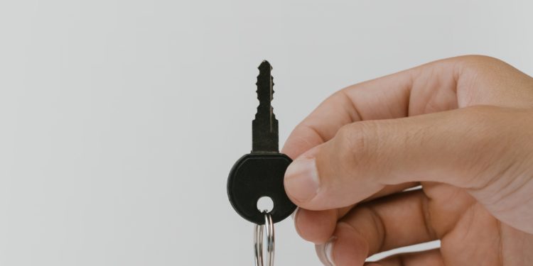 The purpose of this image is to portray security through a key attached to what looks like a memory card.
