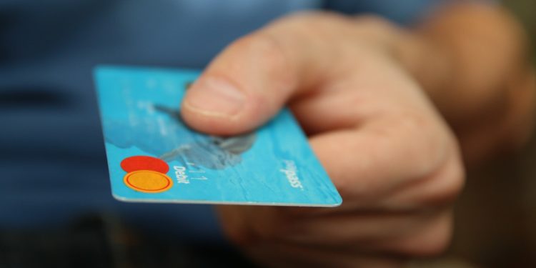Credit card being handed over