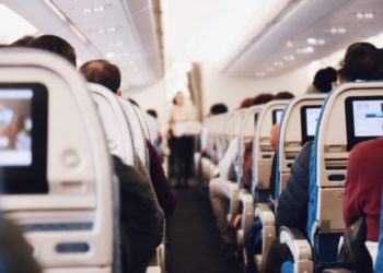 View from the back of an aeroplane aisle.