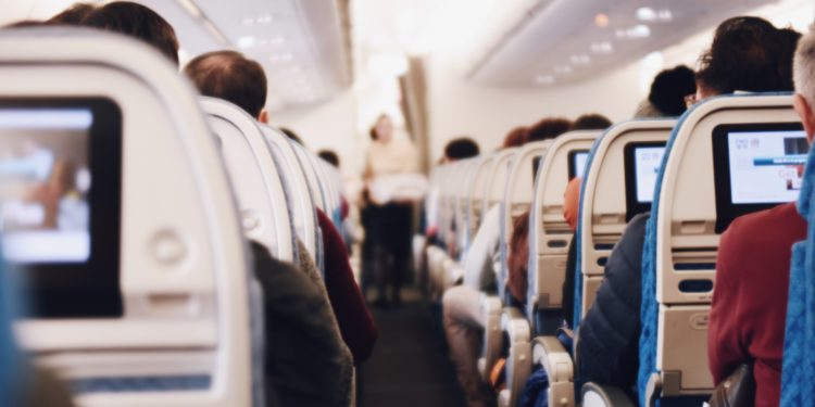 View from the back of an aeroplane aisle.