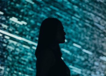 Female silhouette in front of code