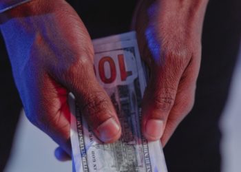 Handcuffed man holding money