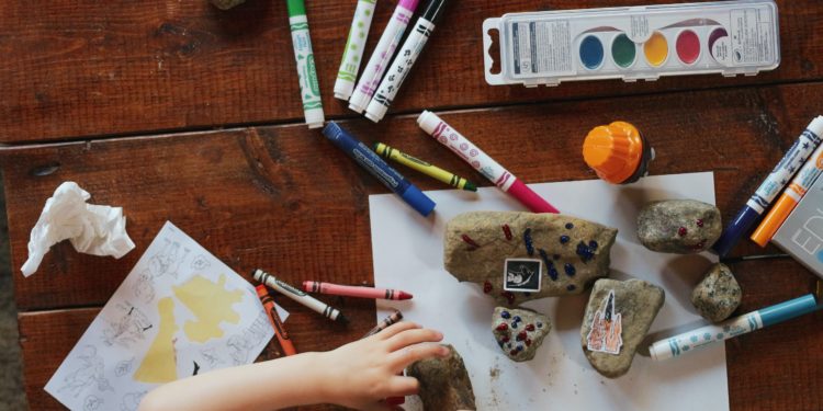 Child playing with crayons