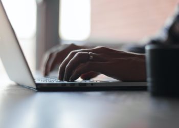 Close up of someone typing on a computer