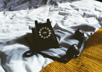 Rotary telephone on a bed