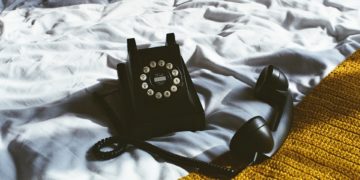 Rotary telephone on a bed