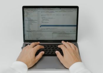 hands typing on a laptop