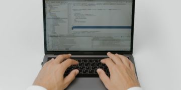 hands typing on a laptop