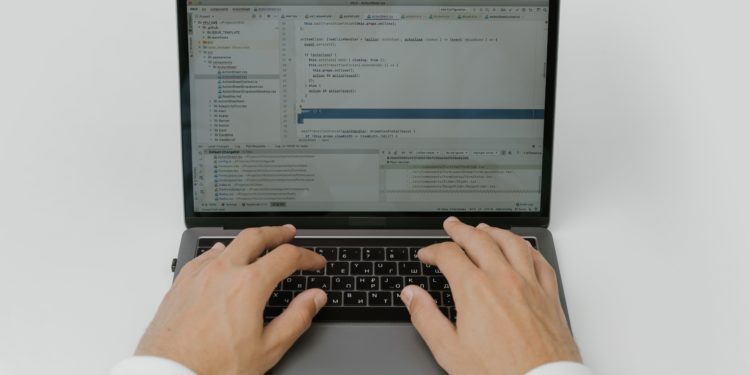 hands typing on a laptop