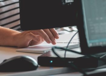 person typing on laptop