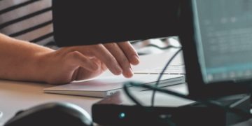 person typing on laptop