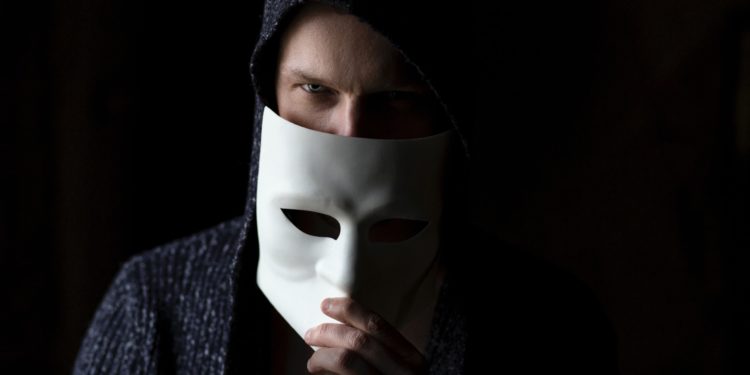man removing mask