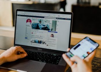 Open laptop and phone using Facebook