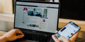 Open laptop and phone using Facebook