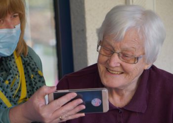 Two people looking at a phone