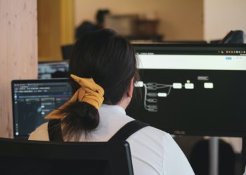 Women sitting at chair in front of computer