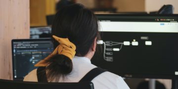 Women sitting at chair in front of computer