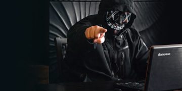 man in mask pointing