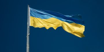 Blue and Yellow flag flying in blue sky (Ukraine)