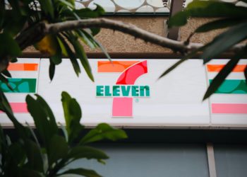 Red, Green and Orange number seven and stripes. Green 'SEVEN' spelled out.