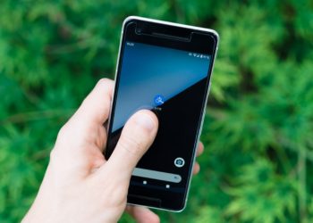Person holding black smartphone.