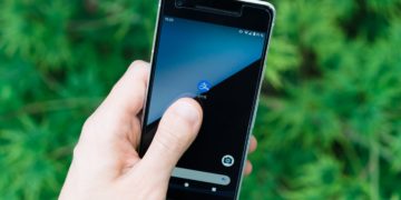 Person holding black smartphone.