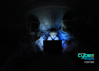 child on laptop in dark room. International Cyber Expo logo in corner.