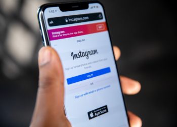 Mobile phone in hand with Instagram app open